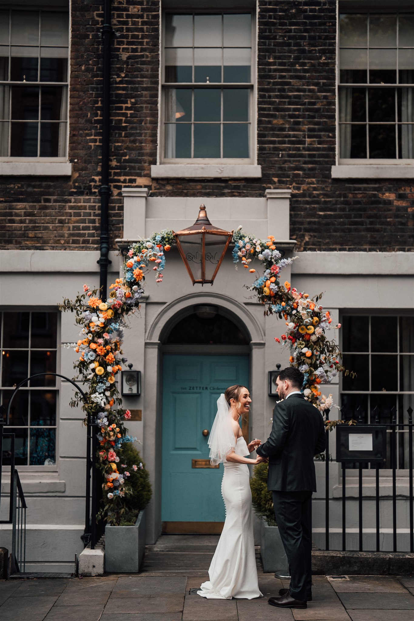 Wedding Couple in front of flower arch