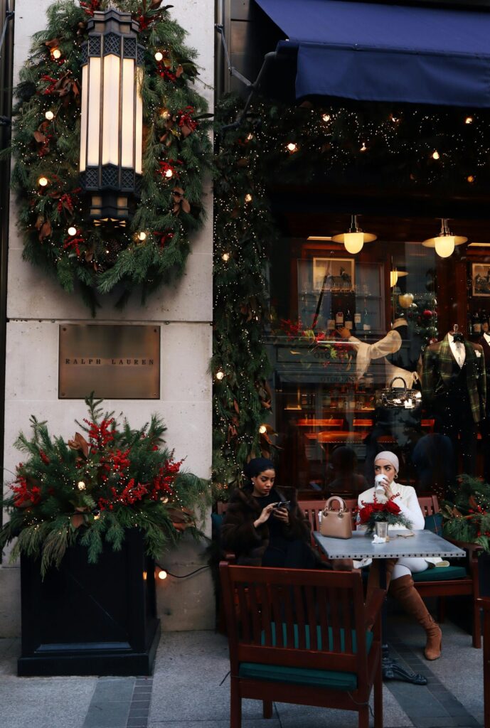 girls drinking hot chocolate by festive decorations marylebone